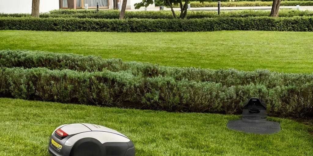 Robotic lawn mowers on a well-maintained grassy area.